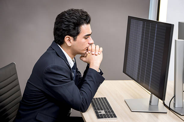 istock Serious young businesswoman looking at desktop screen, analyzing data information at working desk in office. Thinkful data analyst works with desktop computer, feels stressed. Tired business worker 2243201976