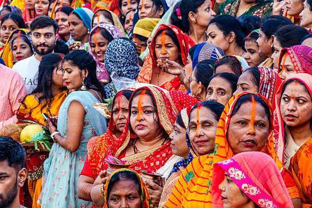 november 8th 2024 uttar pradesh india: Hindu devotees are seen performing rituals on the occasion of chhath puja at the river bank of Ganga & yamuna. Hindu devotees worship the Sun god on the occasion of Chhath Puja. Devotees perform rituals and offer prayers for the prosperity of life and wealth.