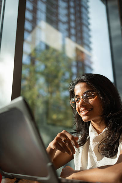 istock Young indian woman smiling while working on laptop 2243205436