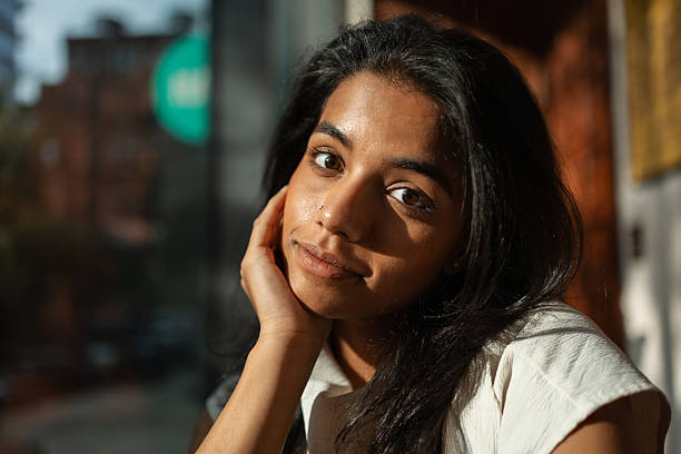 istock Young indian woman looking at camera, pensive portrait 2243205451