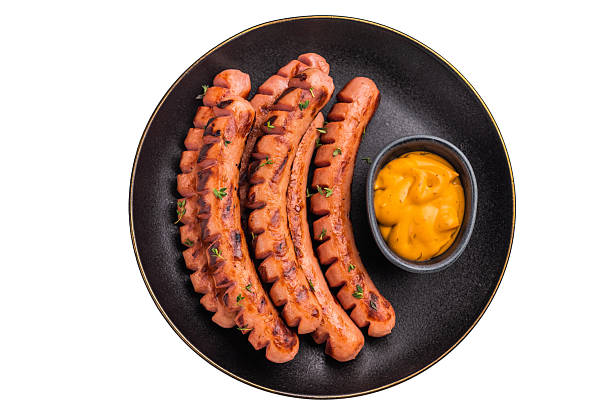 istock Appetizing fried wieners with golden-yellow dipping sauce. Ideal image for a restaurant menu, fast-casual ads, or catering. 2243205670