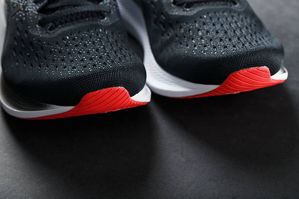 istock Black sports sneakers for training on a dark background 2243210852