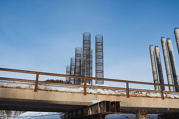 A magnificent bridge is under construction, showcasing its intricate design against a vibrant blue sky, creating a stunning scene that captivates all who pass by this incredible engineering feat