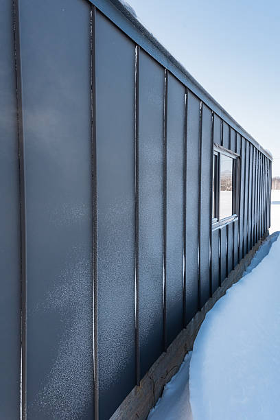 istock The side of a tall building features a window and is beautifully adorned by a fresh layer of white snow. It creates a stunning winter scene that captures the essence of a cold day 2243212818