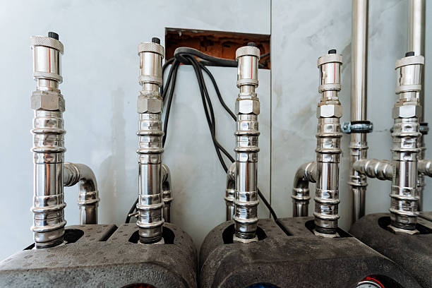 istock Shiny, polished stainless steel pipes are securely fixed to a sturdy wall, highlighting their robust design, versatility, and vital role in plumbing and engineering applications 2243212846