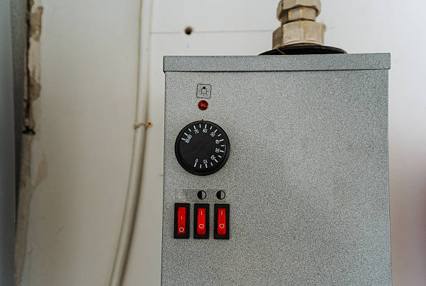 This image features a detailed closeup of a modern thermostat mounted on a wall, showcasing its design and functionality, which is essential for controlling temperature settings in spaces