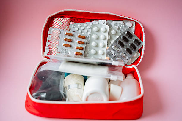 istock A bright red first aid kit, carefully filled with essential items like various pills, several bandages, and a syringe for medical emergencies, is ready for personal care and health needs 2243215556