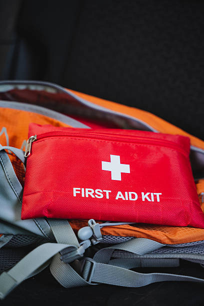 istock A bright and vibrant red first aid kit is positioned confidently atop a wellused backpack, prepared to tackle any emergencies that may arise during outdoor adventures or daily activities 2243215644