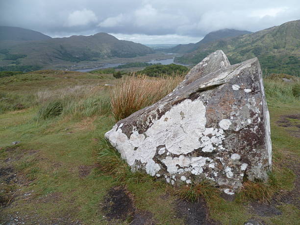 In Ireland, view of a valley with a lake and a big rock in the foreground