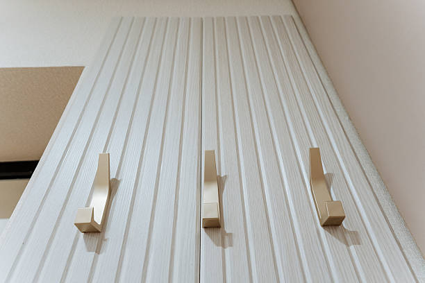 istock A white wall with a row of hooks on it 2243216682