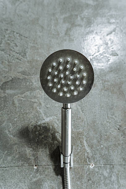 istock This captivating image shows a closeup of a beautifully designed shower head on a rugged concrete floor, highlighting its craftsmanship and the importance of quality household hardware 2243216691