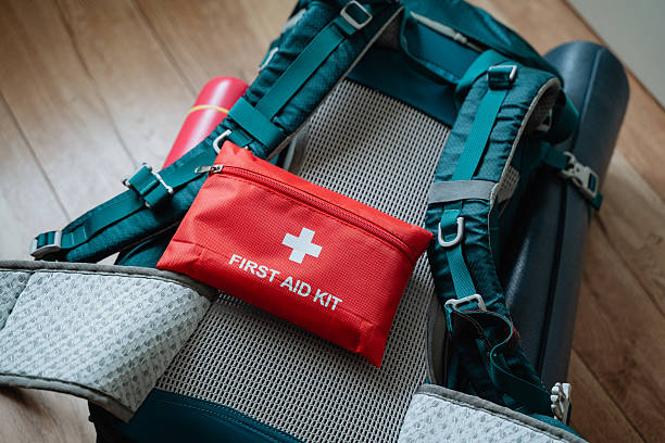 istock A vibrant red first aid kit is prominently perched atop a sturdy backpack, ready for any emergencies that might arise during your travels, ensuring youre always prepared 2243217298