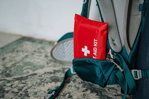 istock A bright red first aid kit is attached to a worn backpack, suggesting its for hiking or outdoor adventures, highlighting the importance of being prepared for emergencies 2243217317