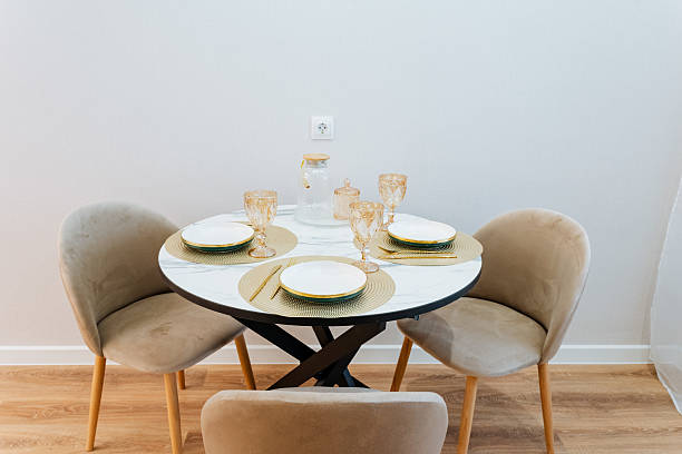 istock A beautifully arranged dining table set, complete with meticulously placed plates and elegant glasses, creates an inviting atmosphere for hosting memorable meals with loved ones and friends 2243218313