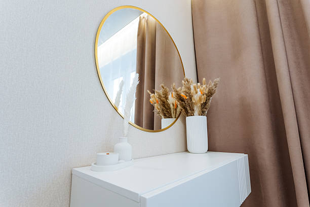 istock Imagine a beautiful dressing table with a large mirror above it, complemented by exquisitely crafted vases filled with vibrant flowers, enhancing the rooms aesthetic appeal 2243218355