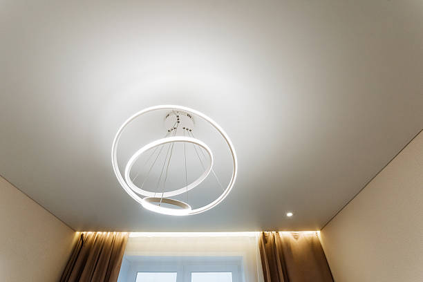 istock The bedroom features a pristine white ceiling adorned with an elegant chandelier gracefully hanging from it, adding a touch of sophistication to the overall decor of the room 2243218371