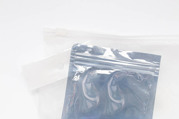 istock Two clear gray plastic bags with a zip closure on a white background, empty packaging for small items 2243220040