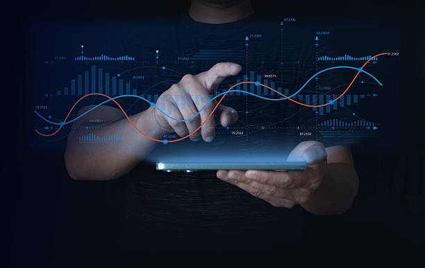 istock Businessman using tablet to analyze digital financial data with glowing line and bar graphs. Concept of big data analytics, fintech, technology, and futuristic business performance visualization. 2243220352
