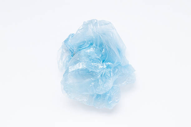 istock Close-up of a blue crumpled plastic bag lying on a white 2243220392