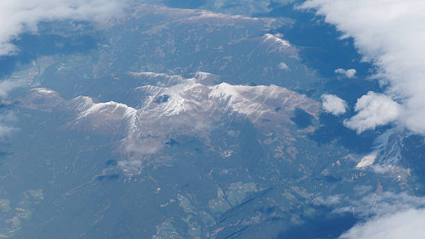istock Mountain Peaks Seen from Above Through the Clouds 2243221658