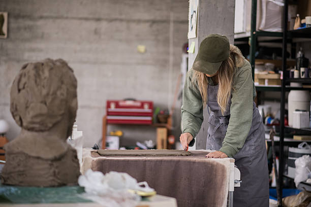 istock Female Potter Polishing Clay Piece 2243223099