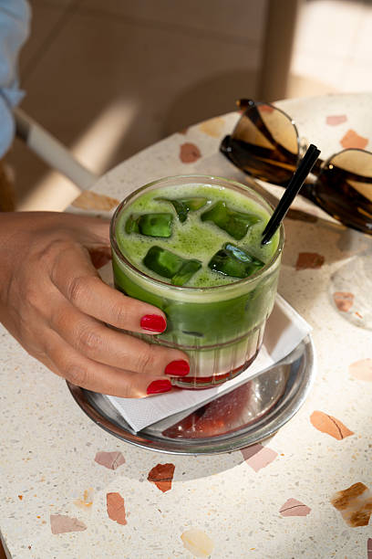 istock Woman holding a refreshing iced matcha latte with a straw 2243224205
