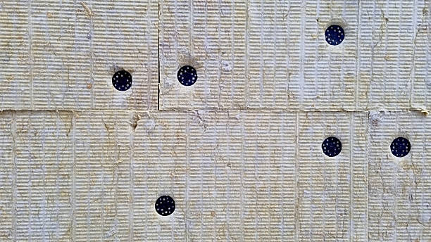 istock A detail of wall pressed thermal insulation materials,  and attached with dowels 2243224416