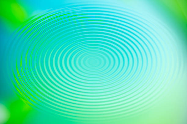 Abstract circular pattern in shades of blue, green and purple, radiating from a central point. Futuristic background