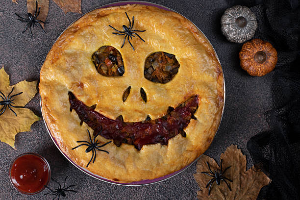 istock Halloween homemade vegetables pie with scary face. Autumn theme Top view 2243232448