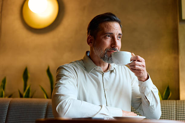 istock Mature man enjoying coffee relaxing in a cafe 2243236631