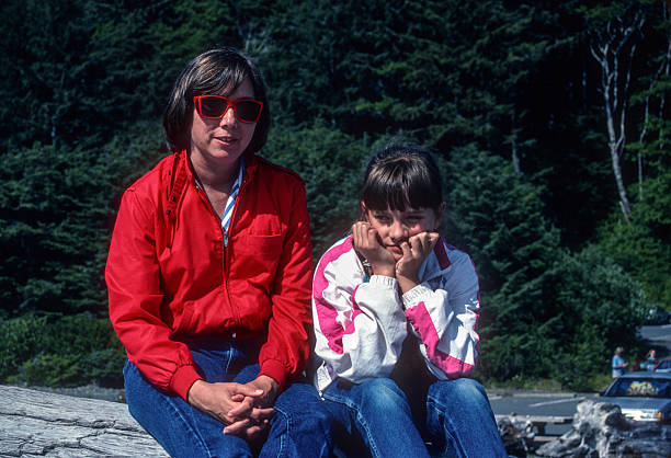 istock Olympic NP - Rialto Beach - Mother & Daughter on Log - 1989 2243241709