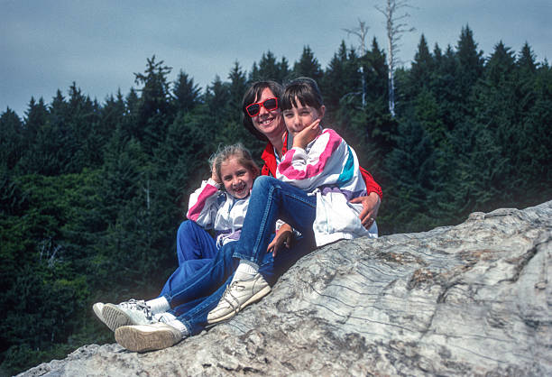 Selfie of mother and adult daughter in meadow while hiking