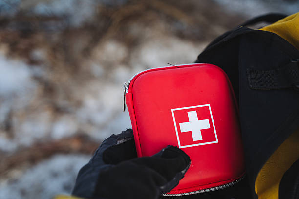 istock A person is firmly holding a brightly colored red first aid kit that features a distinctive white cross symbol, making it easily identifiable during emergencies for quick access 2243243506