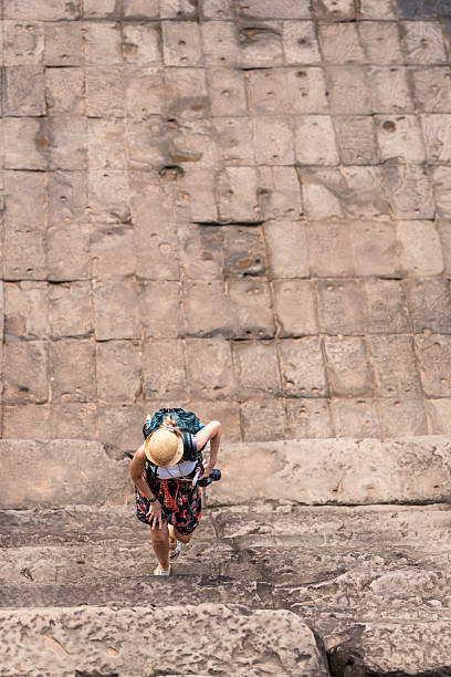 istock Woman tourist with backpack climbing ancient temple stairs 2243249173
