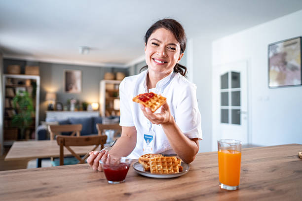 istock Female nurse eating waffles with jam for breakfast 2243256289