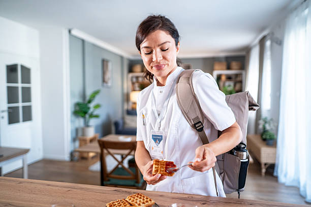 istock Female healthcare worker eating breakfast rushing morning routine 2243256311