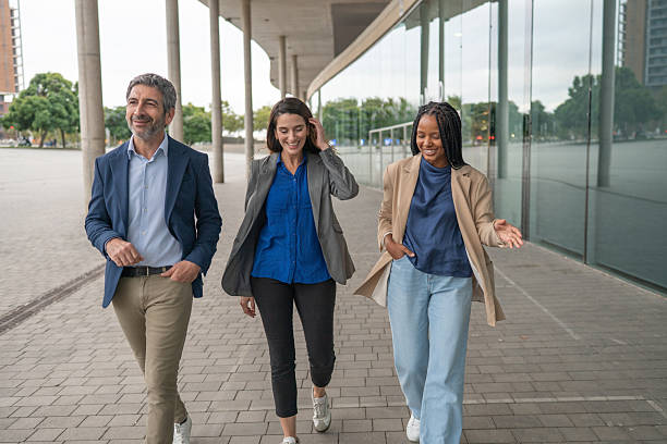 istock Diverse business colleagues walking and collaborating discussing work 2243256349