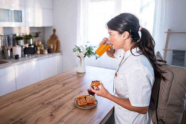 istock Woman drinking juice, eating waffles during morning breakfast 2243256443