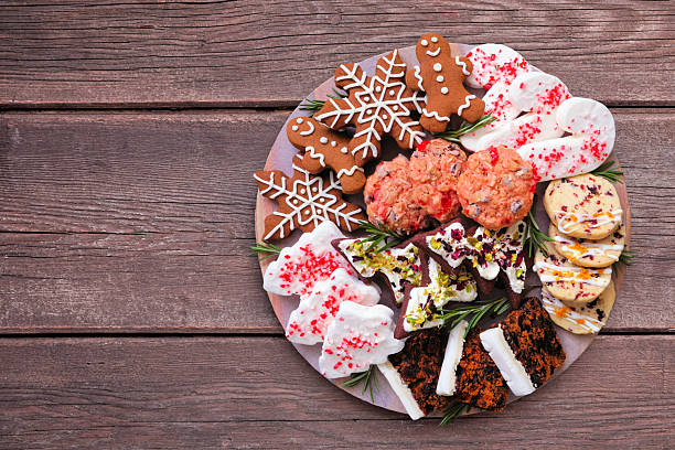 istock Christmas dessert platter. Top view on a dark wood background. 2243257098