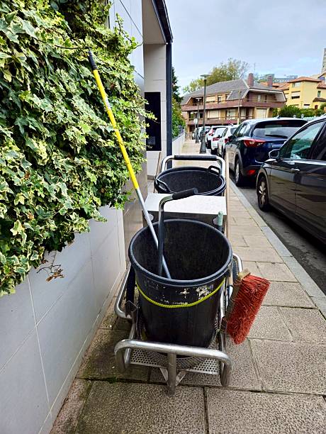 istock Garbage cleaner and street sweeper bucket. Cleaning services 2243257137