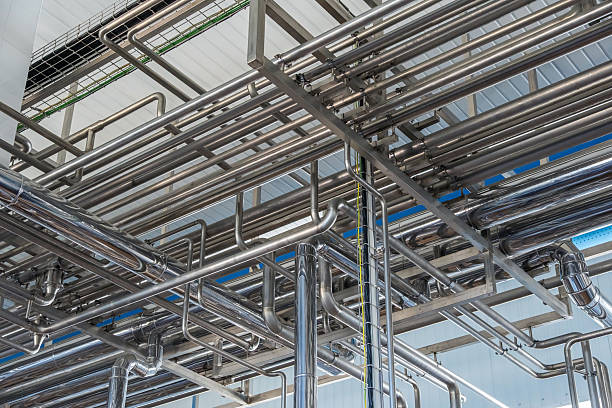 istock Stainless steel pipes under ceiling in industrial facility 2243260122
