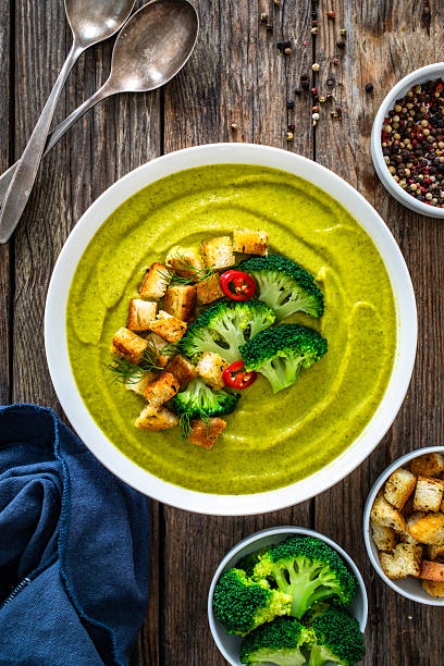 Cream broccoli soup on wooden table