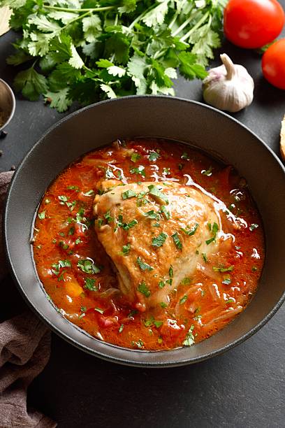 Baked chicken with tomato gravy and herbs