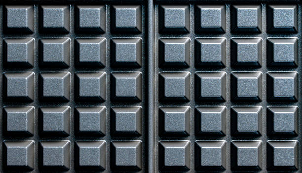 istock Black waffle non-stick die-cast aluminum plates for design purpose, closeup. Waffle maker plate as background or texture 2243265411