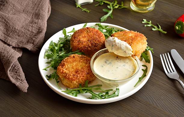 Delicious fish cakes from mashed potato and minced fish served with dipping sauce