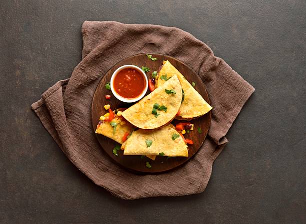 istock Delicious quesadillas with fresh vegetables served with tomato sauce 2243269646