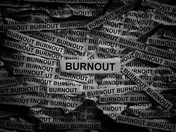istock Strips of newspaper with the words Burnout typed on them. 2243270924