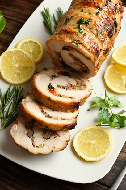 istock Stuffed pork tenderloin loaded with fried mushrooms, onion, red 2243271684