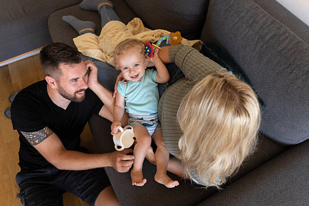 istock Parents Try Napping On The Sofa With Their Baby 2243276430