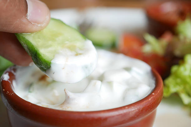 istock Fresh cucumber dipped in tangy yogurt sauce 2243279478